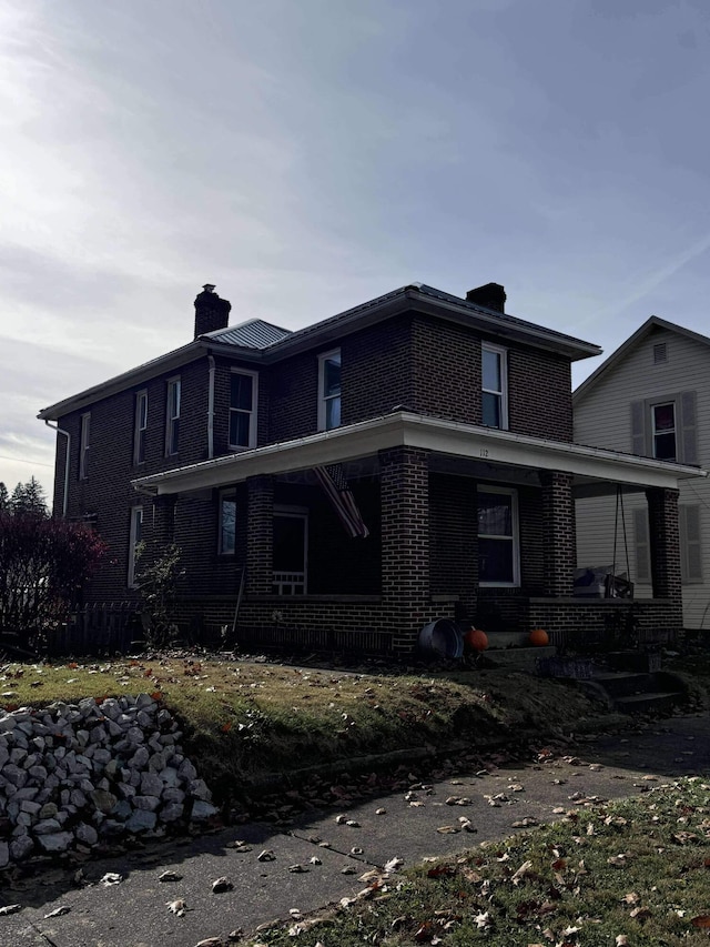 rear view of house featuring a porch