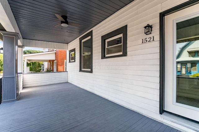 wooden deck with ceiling fan and a porch