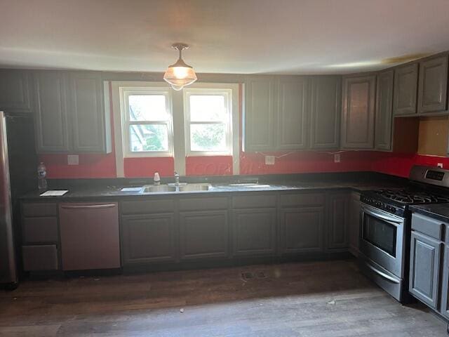 kitchen with dark hardwood / wood-style flooring, sink, and stainless steel appliances