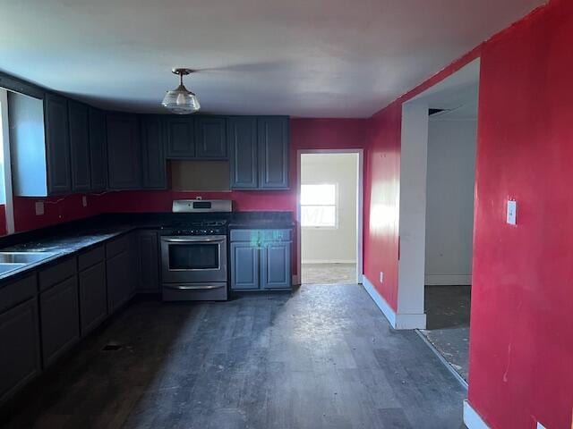 kitchen with dark wood-type flooring and stainless steel stove