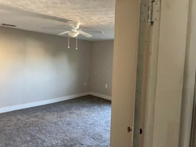 unfurnished room featuring ceiling fan, carpet floors, and a textured ceiling