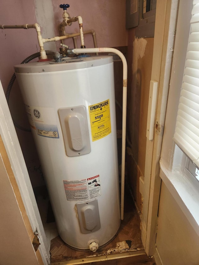 utility room featuring electric water heater