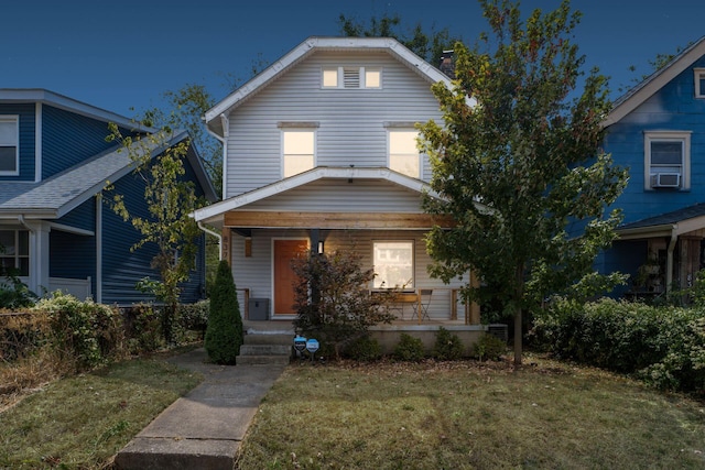 view of front of home featuring a front lawn and cooling unit