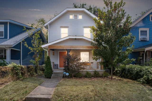 view of front of property with a yard and cooling unit