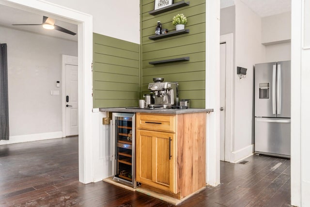 bar featuring stainless steel fridge, dark hardwood / wood-style flooring, wine cooler, and ceiling fan