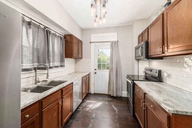 kitchen with sink, light stone countertops, tasteful backsplash, dark hardwood / wood-style flooring, and stainless steel appliances