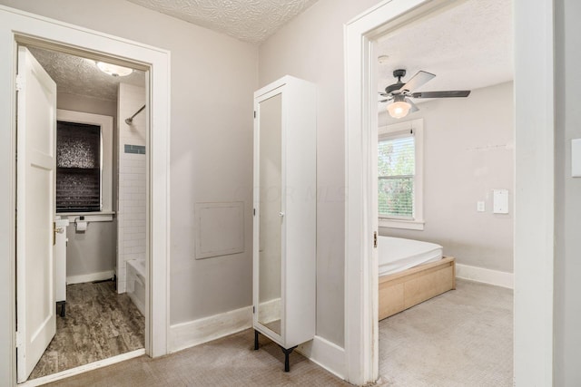 bathroom with ceiling fan, a textured ceiling, and independent shower and bath