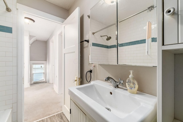 bathroom with sink, wood-type flooring, and a textured ceiling