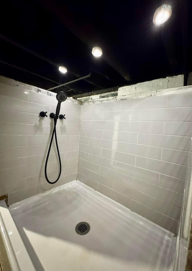 bathroom with a tile shower