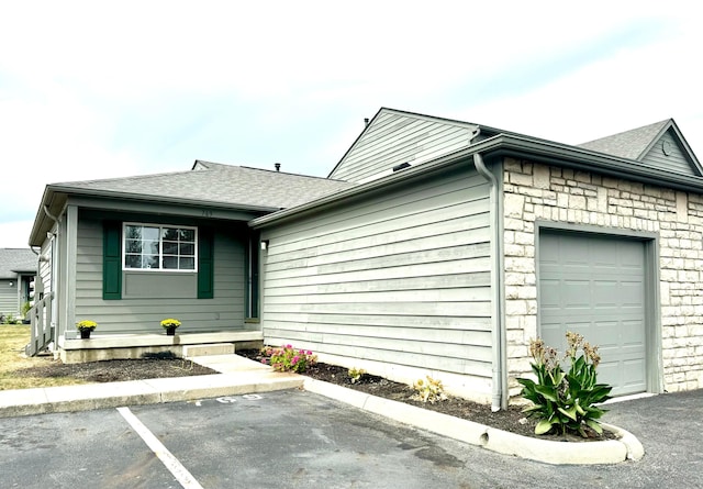 view of side of home featuring a garage