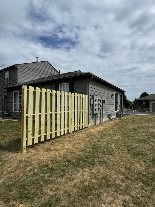 view of side of home featuring a lawn