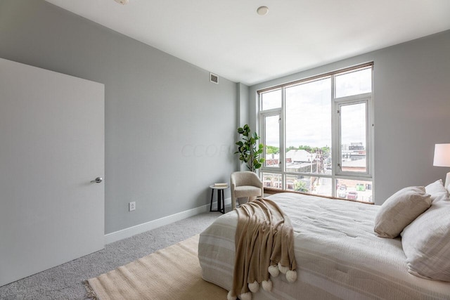 bedroom featuring light carpet