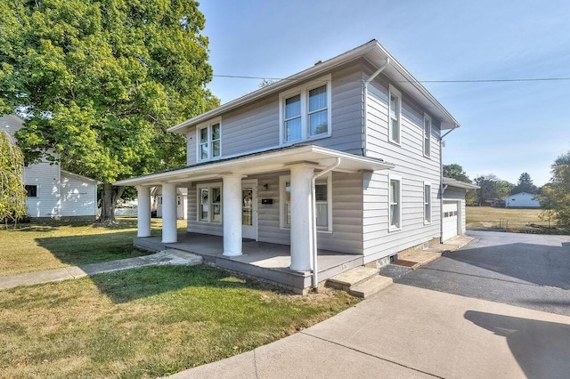 view of front facade featuring a front yard, a porch, and a garage