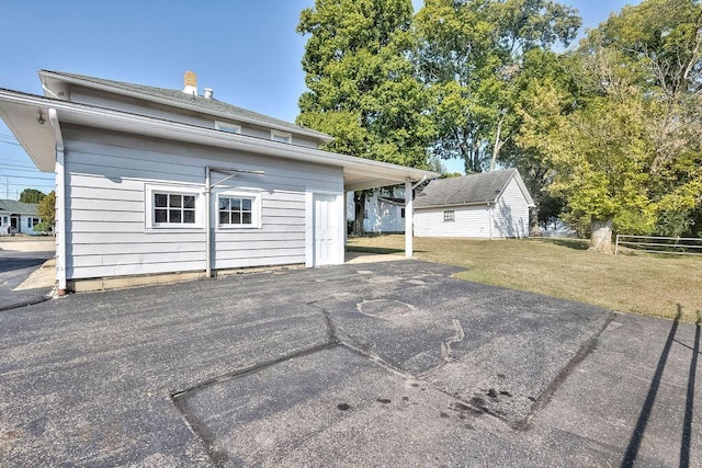 702 Coshocton Ave, Mount Vernon, OH 43050 - back of house with an outdoor structure, a chimney, and a patio