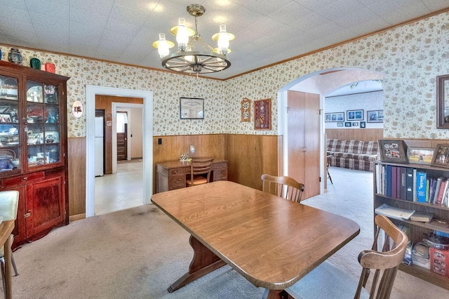 702 Coshocton Ave, Mount Vernon, OH 43050 - dining room featuring crown molding, arched walkways, a wainscoted wall, a chandelier, and wallpapered walls