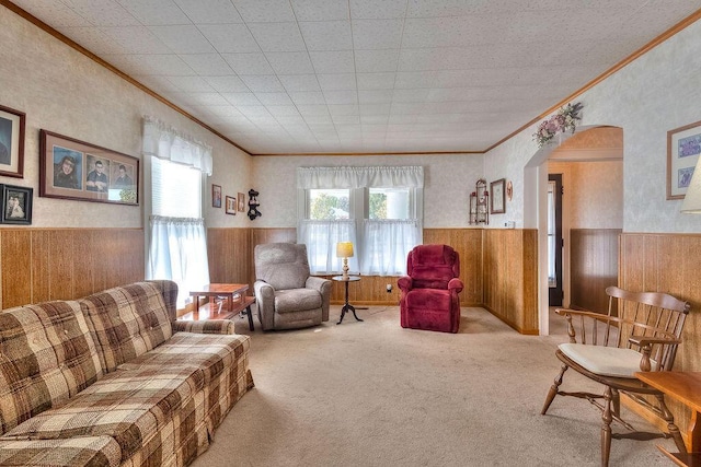 702 Coshocton Ave, Mount Vernon, OH 43050 - living area with a wainscoted wall, ornamental molding, arched walkways, wooden walls, and carpet flooring
