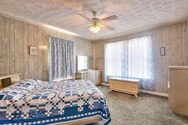702 Coshocton Ave, Mount Vernon, OH 43050 - carpeted bedroom featuring wood walls, a textured ceiling, and a ceiling fan