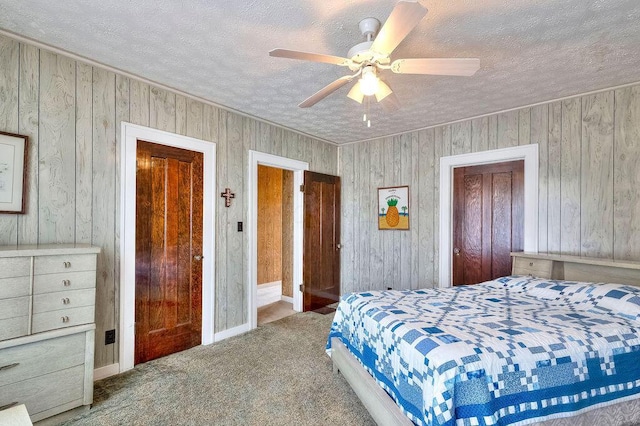 702 Coshocton Ave, Mount Vernon, OH 43050 - carpeted bedroom with a textured ceiling, wooden walls, and a ceiling fan