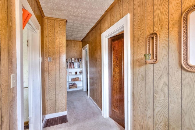 702 Coshocton Ave, Mount Vernon, OH 43050 - hall with wood walls, a textured ceiling, and carpet