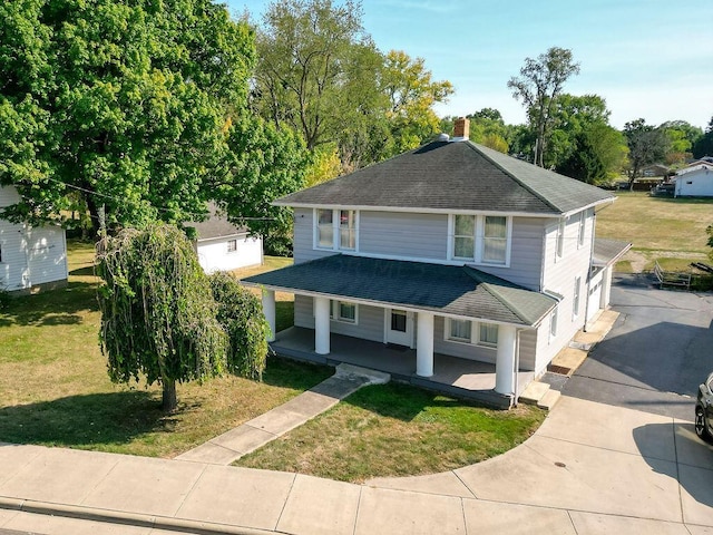 702 Coshocton Ave, Mount Vernon, OH 43050 - view of front of home with a shingled roof, driveway, covered porch, and a front yard