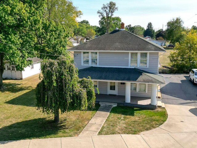 702 Coshocton Ave, Mount Vernon, OH 43050 - american foursquare style home with roof with shingles, a front lawn, and covered porch