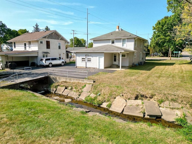 702 Coshocton Ave, Mount Vernon, OH 43050 - back of house featuring a lawn