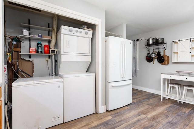 3611 Gerbert Rd, Columbus, OH 43224 - laundry room featuring stacked washing machine and dryer, wood finished floors, and baseboards