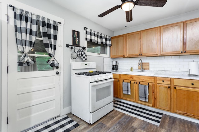 3611 Gerbert Rd, Columbus, OH 43224 - kitchen featuring white gas range, a sink, light countertops, and decorative backsplash