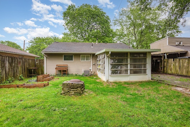 3611 Gerbert Rd, Columbus, OH 43224 - back of house with a fire pit, central AC, and a sunroom