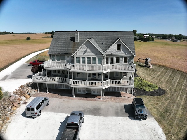 back of house featuring a balcony