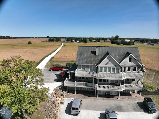 back of property featuring a rural view