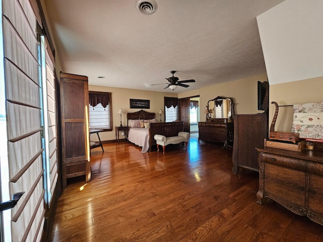 bedroom with a textured ceiling and dark wood-type flooring