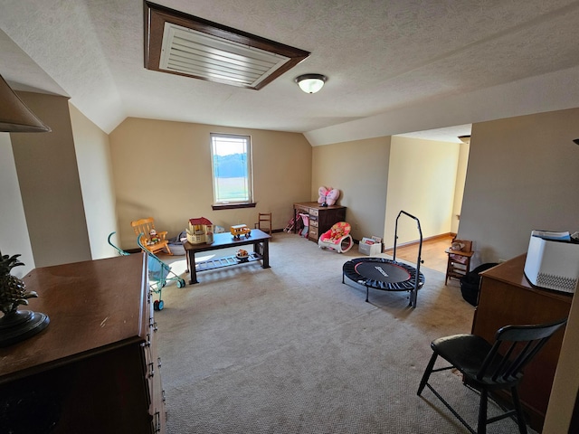 rec room with light colored carpet, a textured ceiling, and vaulted ceiling