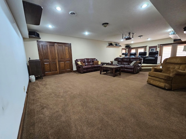 living room featuring carpet and a textured ceiling