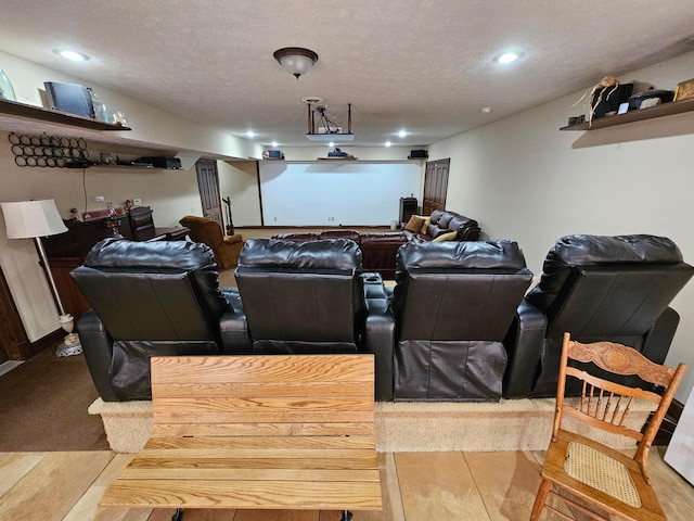 home theater room with wood-type flooring and a textured ceiling