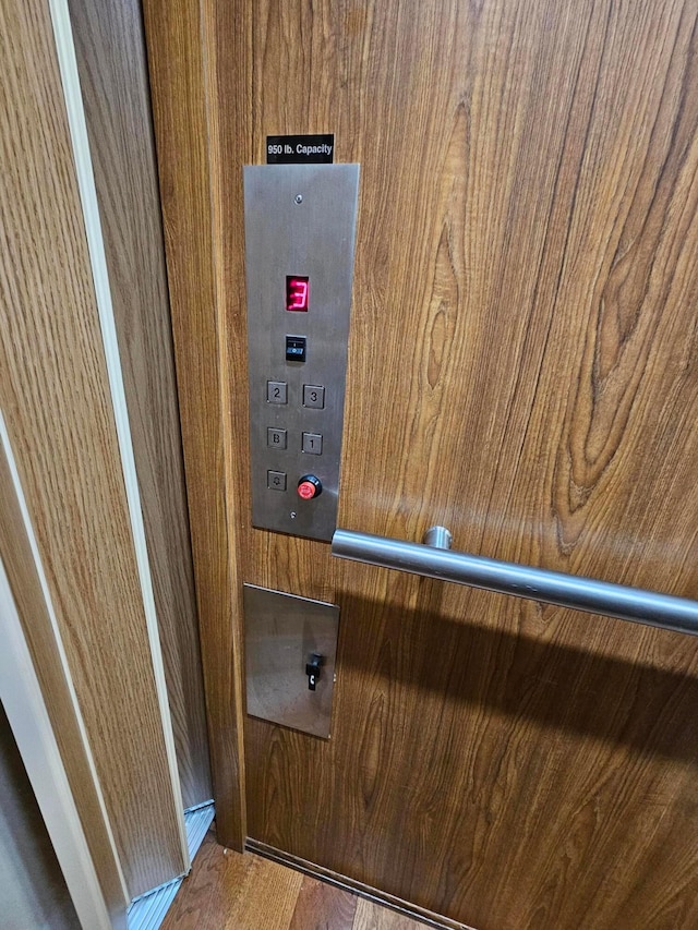 details with wood-type flooring and elevator