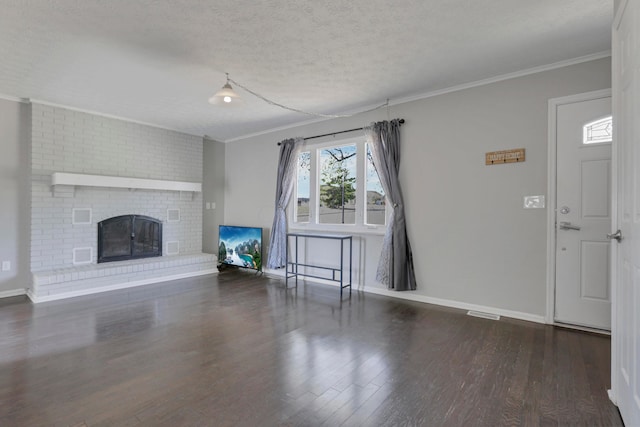 unfurnished living room featuring a fireplace, dark hardwood / wood-style flooring, and a textured ceiling