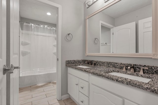 bathroom featuring shower / tub combo and vanity