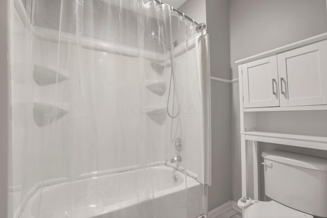 bathroom with shower / bath combo and toilet