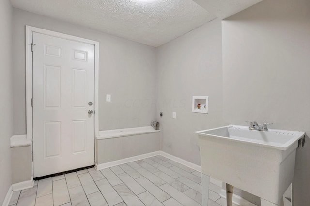 laundry area with washer hookup, a textured ceiling, electric dryer hookup, and sink