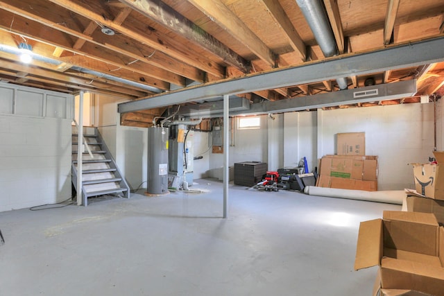 basement featuring electric water heater and electric panel