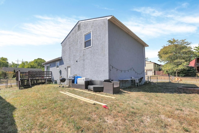 rear view of house featuring a yard