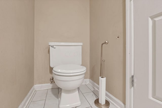 bathroom with toilet and tile patterned floors