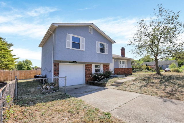 view of front of home with a front yard and a garage