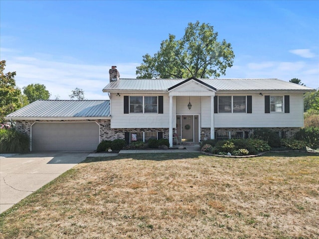 raised ranch with a garage and a front yard