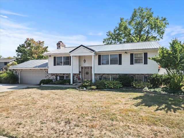 split foyer home with a front yard and a garage