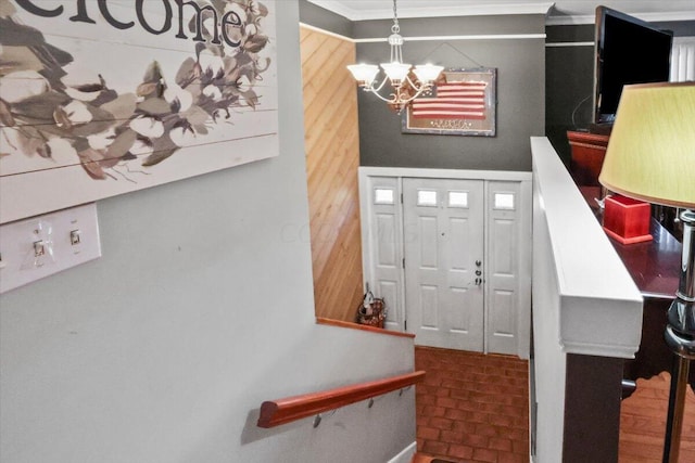 foyer entrance with an inviting chandelier and wood walls