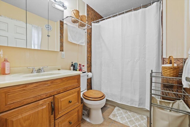 bathroom featuring toilet, tile patterned floors, curtained shower, and vanity