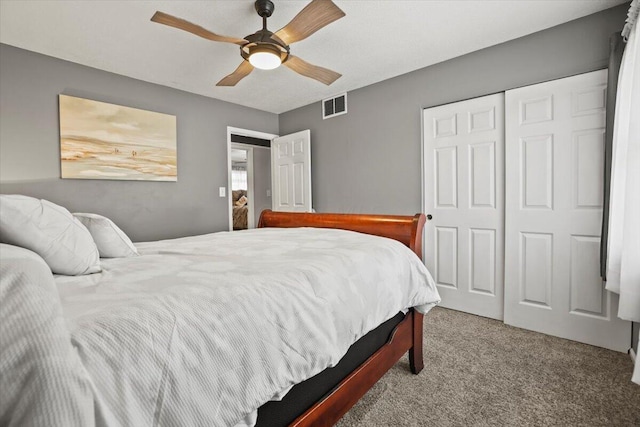 carpeted bedroom with a ceiling fan, visible vents, and a closet