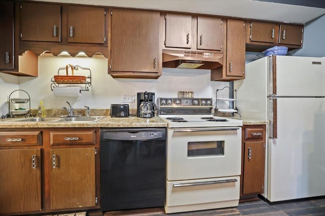 kitchen featuring white appliances, dark wood-type flooring, and sink